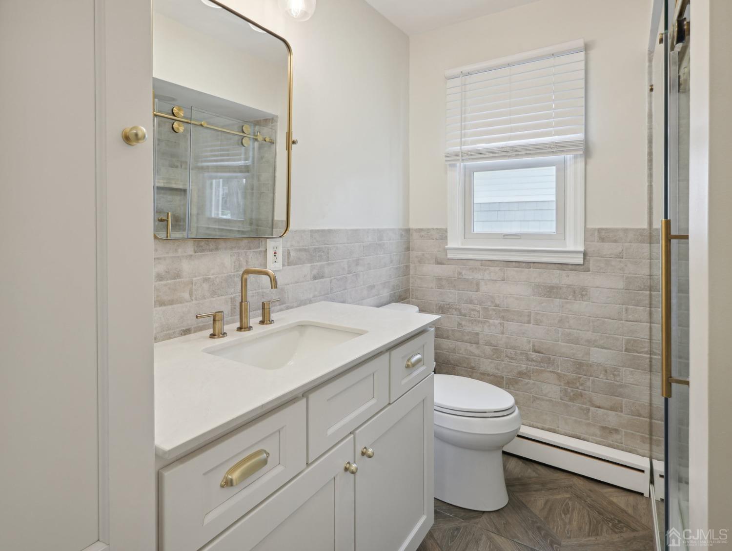 82 Normandy Road Colonia, NJ 07067 - Photo 16 of 33 a bathroom with a sink toilet and vanity