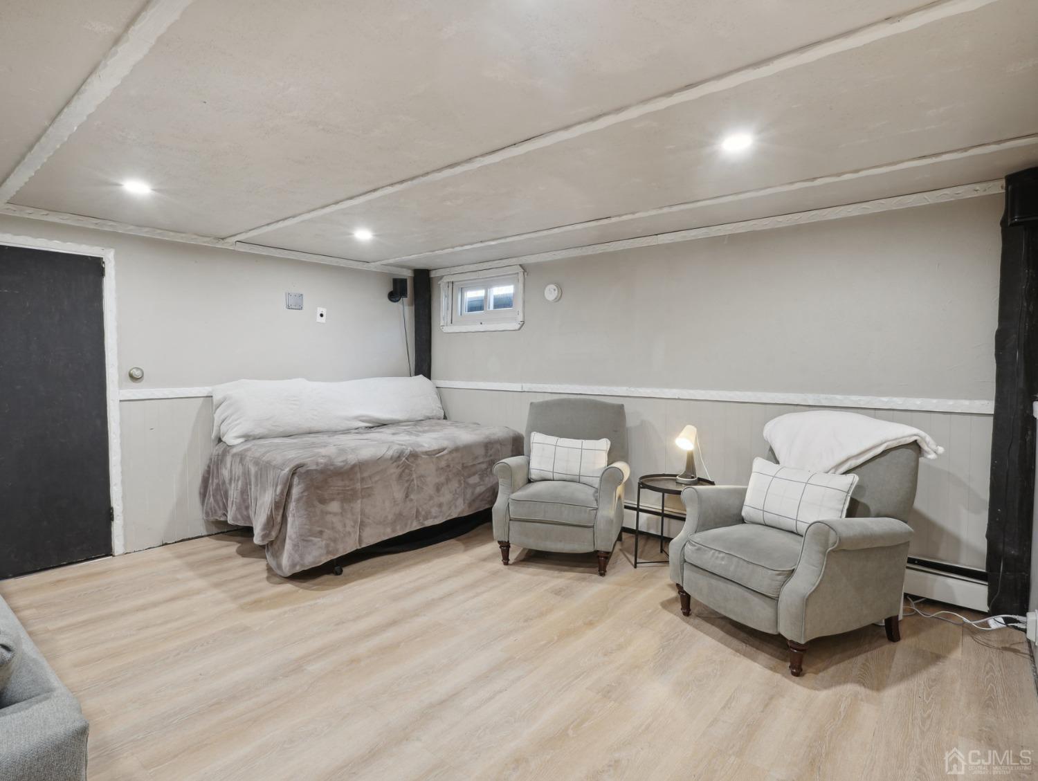 82 Normandy Road Colonia, NJ 07067 - Photo 19 of 33 a spacious bedroom with a bed and a couch