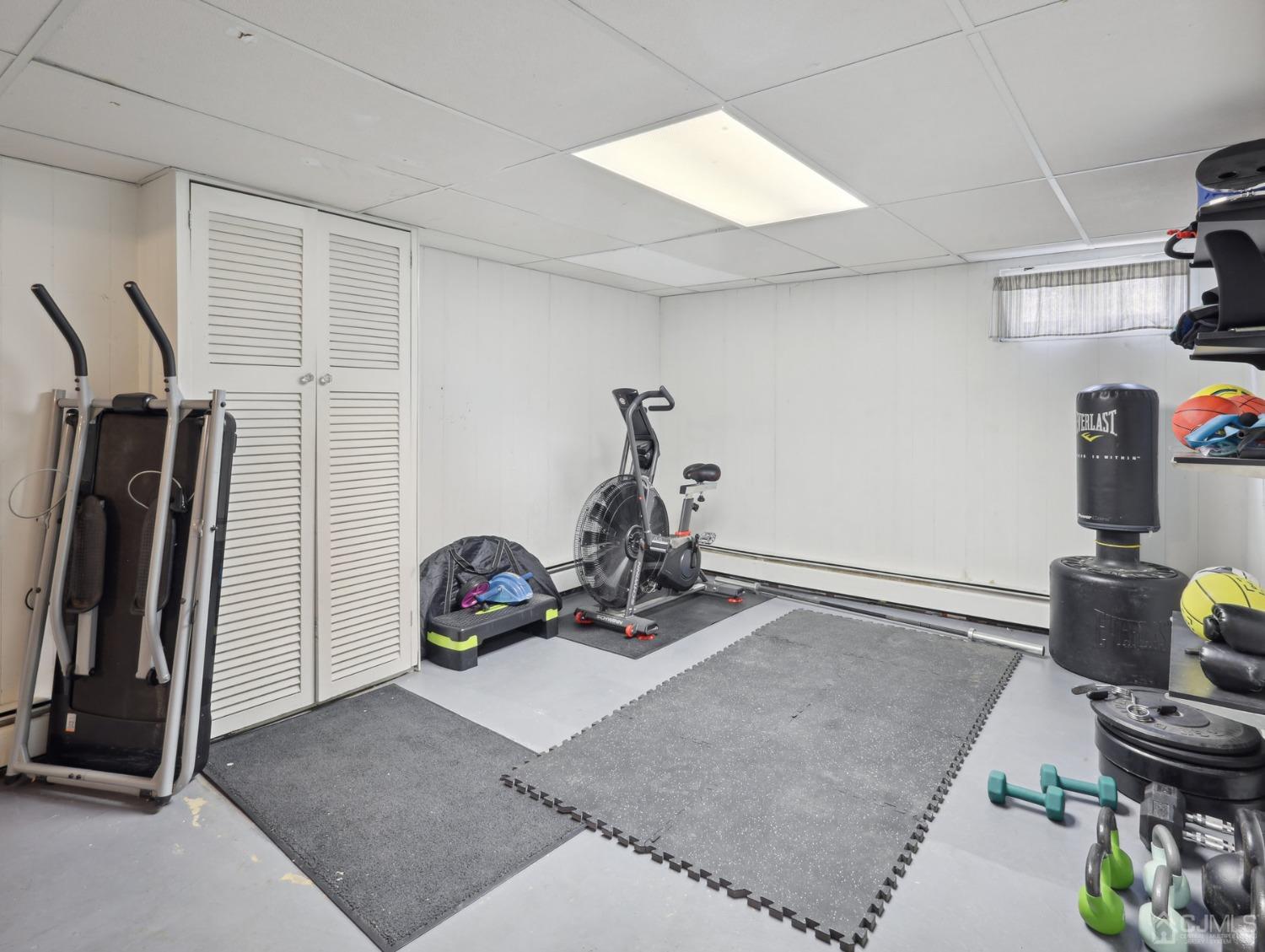 82 Normandy Road Colonia, NJ 07067 - Photo 22 of 33 a room with gym equipment and a window