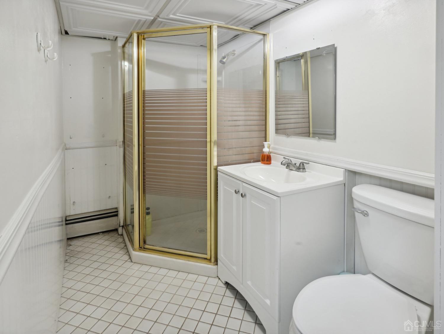 82 Normandy Road Colonia, NJ 07067 - Photo 24 of 33 a bathroom with a sink a toilet a mirror and shower
