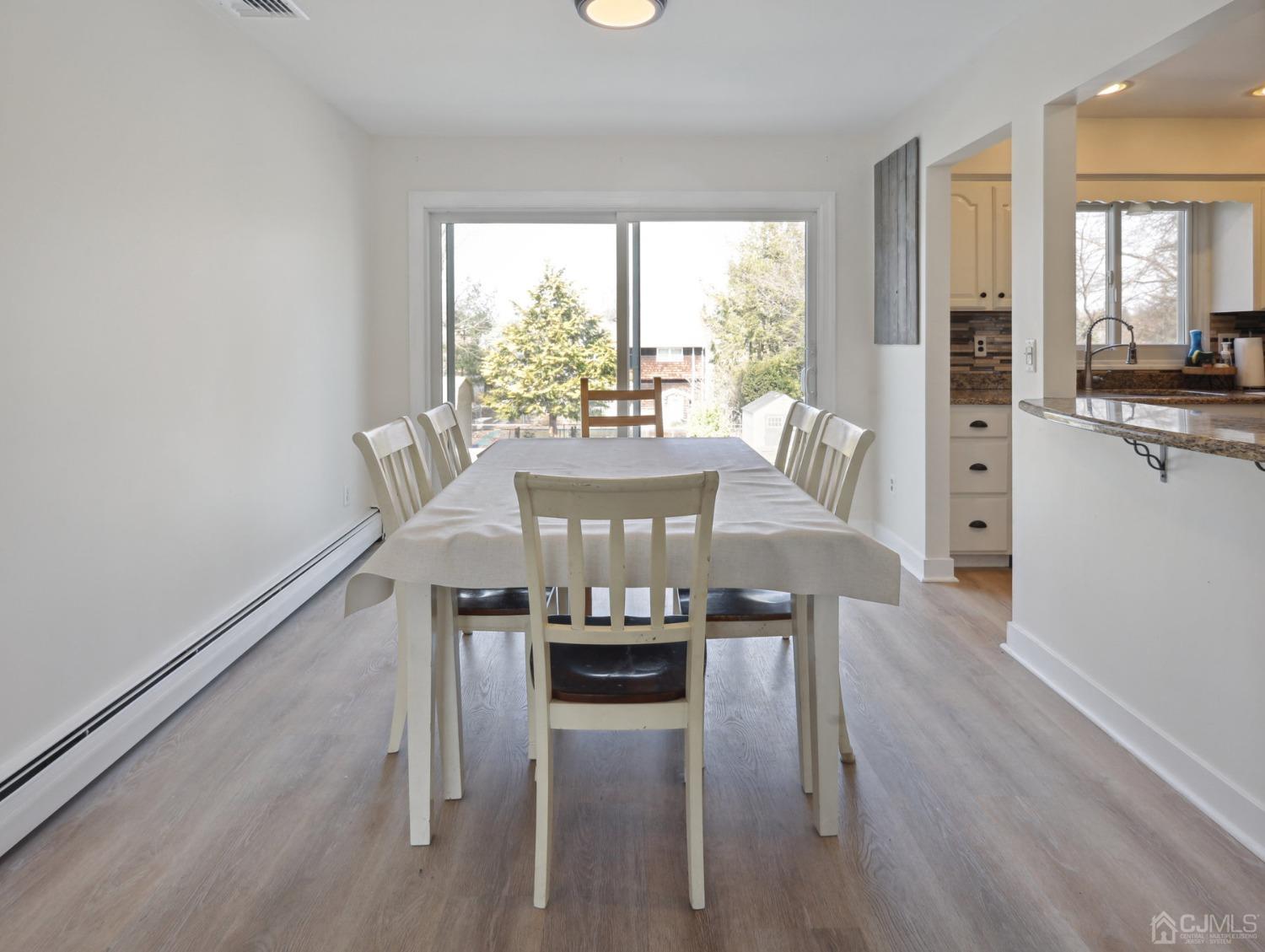 82 Normandy Road Colonia, NJ 07067 - Photo 5 of 33 a view of a dining room with furniture window and wooden floor