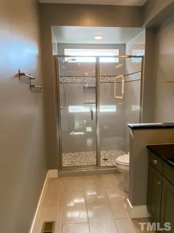 a bathroom with a glass shower door