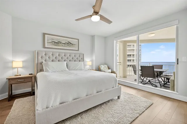 a bedroom with a bed and ceiling fan