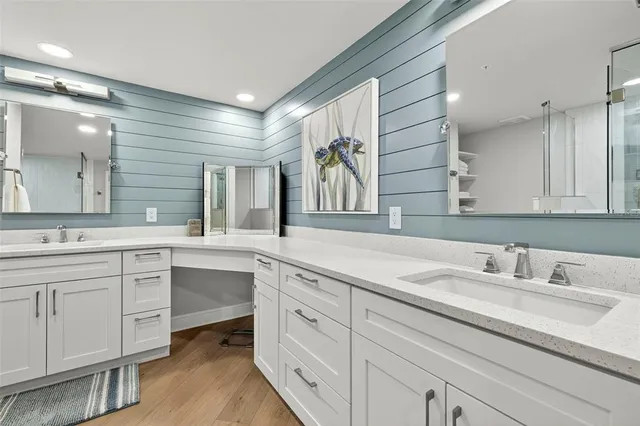 a bathroom with a sink double vanity granite and a mirror