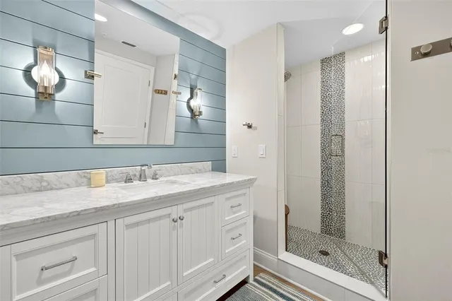 a bathroom with a granite countertop sink mirror and double