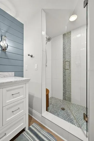 a bathroom with a shower and a sink