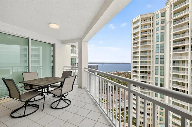 a view of a balcony dining table and chairs with wooden floor