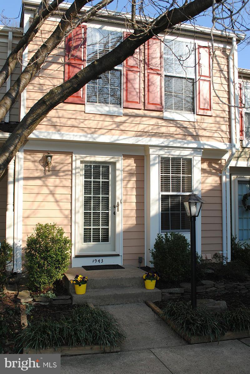 1943 Belmont Ridge Court Reston, VA 20191 - Photo 1 of 26 a front view of a house with garden