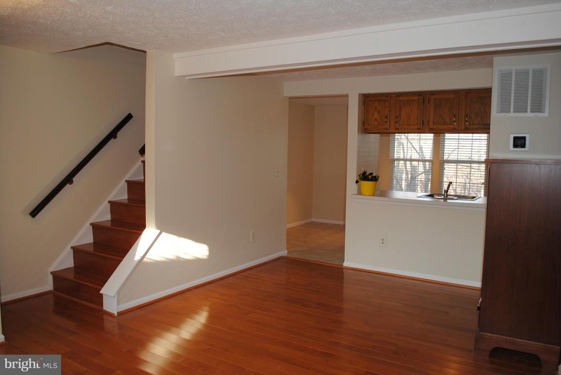 1943 Belmont Ridge Court Reston, VA 20191 - Photo 2 of 26 a view of an empty room with wooden floor and a window
