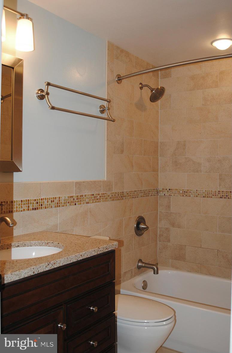 1943 Belmont Ridge Court Reston, VA 20191 - Photo 14 of 26 a bathroom with a sink a toilet and shower