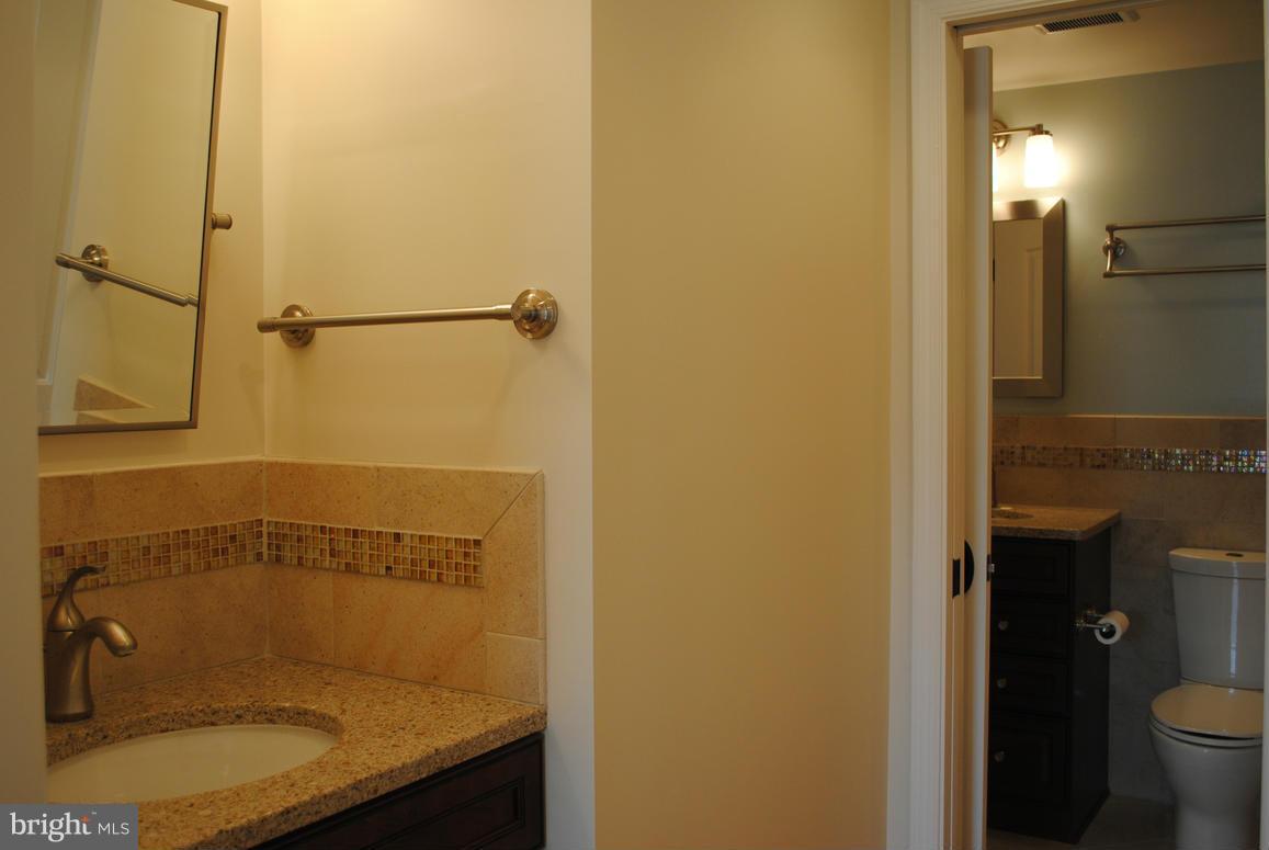 1943 Belmont Ridge Court Reston, VA 20191 - Photo 15 of 26 a bathroom with a granite countertop sink mirror and shower
