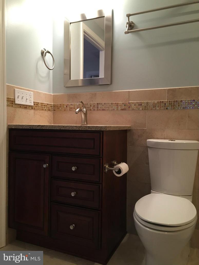1943 Belmont Ridge Court Reston, VA 20191 - Photo 16 of 26 a bathroom with a granite countertop toilet sink and mirror