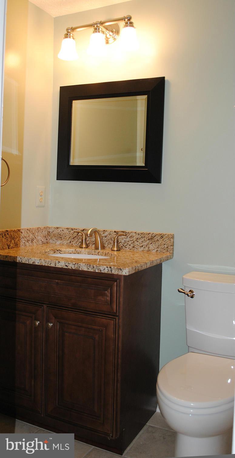 1943 Belmont Ridge Court Reston, VA 20191 - Photo 19 of 26 a bathroom with a sink a mirror and a toilet