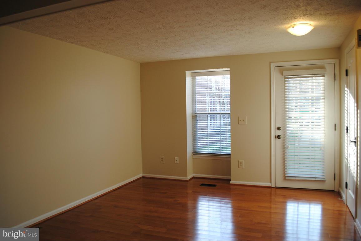 1943 Belmont Ridge Court Reston, VA 20191 - Photo 3 of 26 an empty room with wooden floor and windows