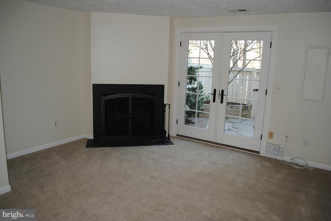 1943 Belmont Ridge Court Reston, VA 20191 - Photo 21 of 26 a view of empty room with windows and fireplace