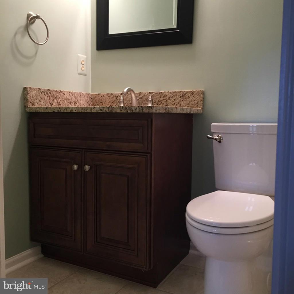 1943 Belmont Ridge Court Reston, VA 20191 - Photo 24 of 26 a bathroom with a granite countertop toilet and sink
