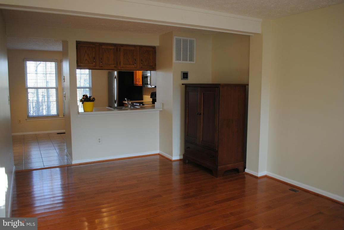 1943 Belmont Ridge Court Reston, VA 20191 - Photo 5 of 26 an empty room with wooden floor and windows