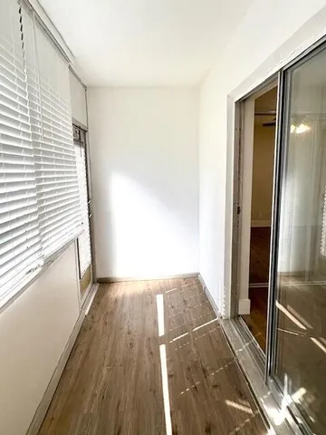 a view of a room with wooden floor and staircase