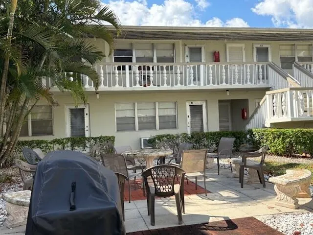 a view of house with a chairs and table in a patio