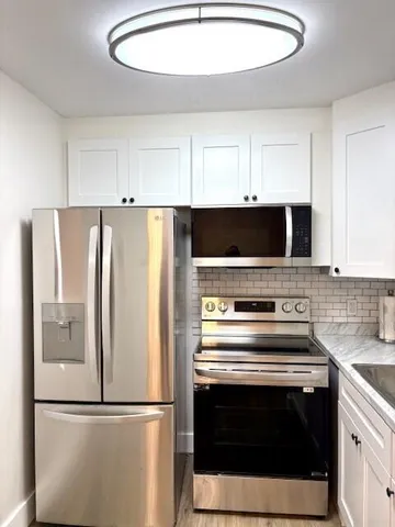 a kitchen with a stainless steel appliances and cabinets