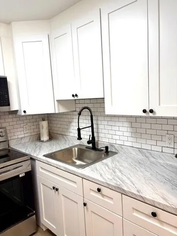a kitchen with a sink and a window
