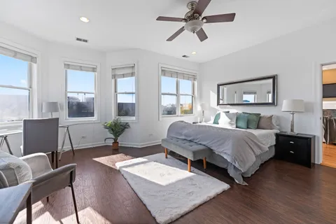 a bedroom with a bed a couch and dresser