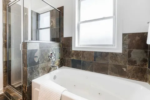 a bathroom with a bathtub and shower