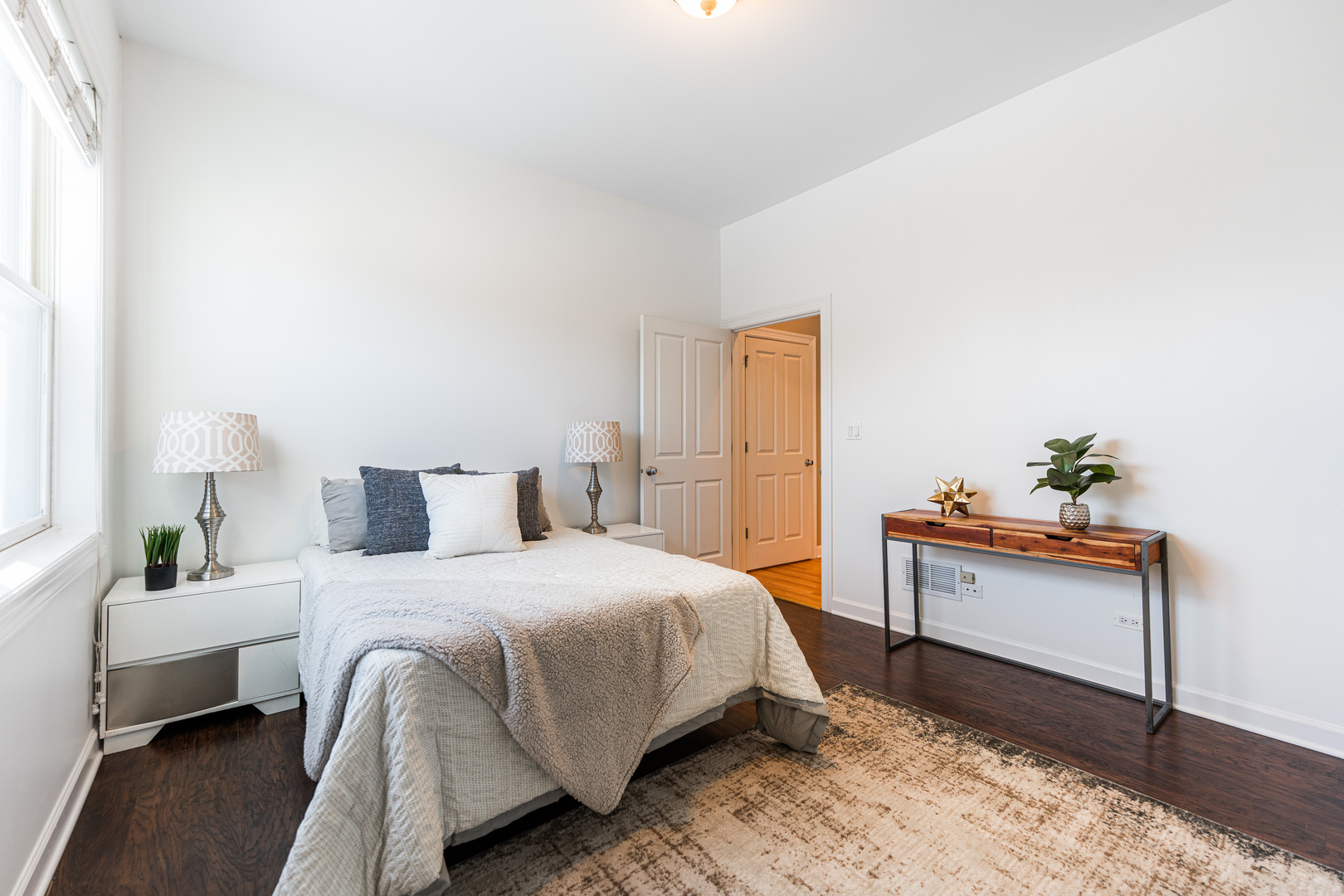 4603 North Racine Avenue, Unit 403 Chicago, IL 60640 - Photo 17 of 21 a bedroom with a bed and wooden floor