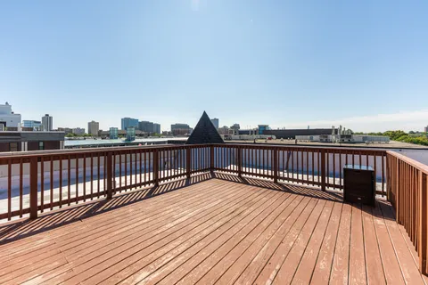 a view of balcony with wooden floor