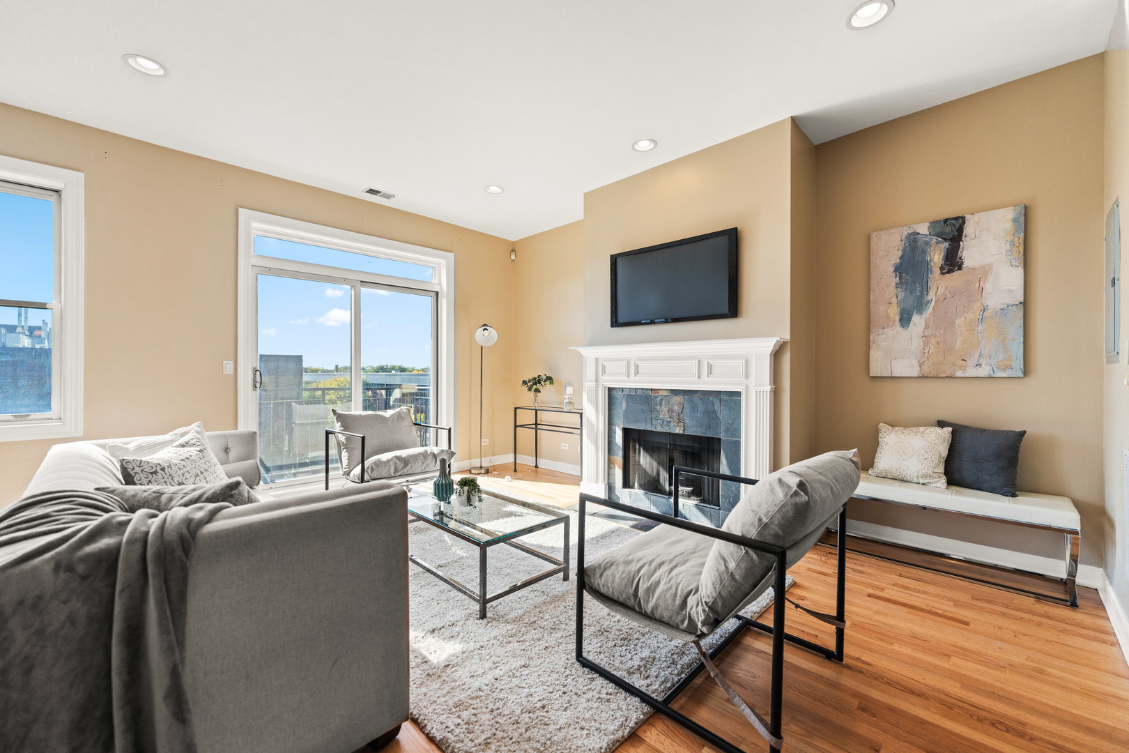 4603 North Racine Avenue, Unit 403 Chicago, IL 60640 - Photo 3 of 21 a living room with furniture fireplace and a flat screen tv