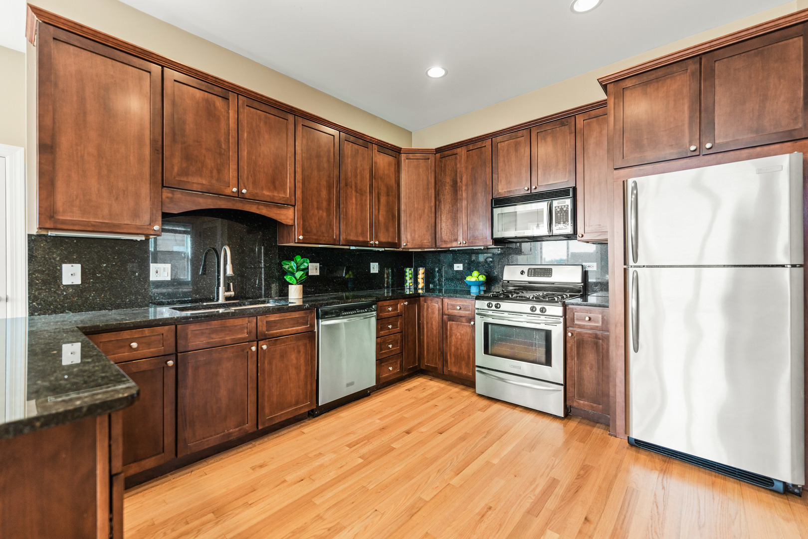 4603 North Racine Avenue, Unit 403 Chicago, IL 60640 - Photo 7 of 21 a kitchen with stainless steel appliances granite countertop a refrigerator sink and cabinets
