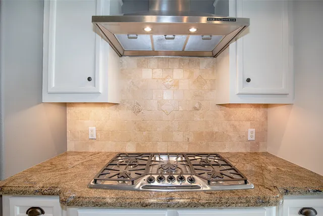 a kitchen with stainless steel appliances granite countertop a sink a microwave and island