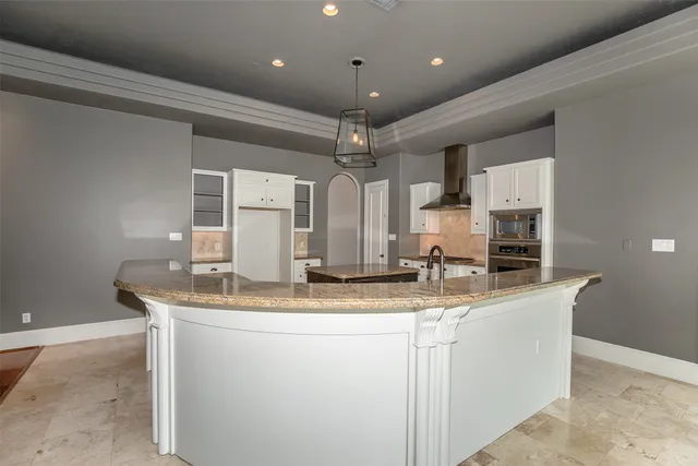 a view of a room with a large window and chandelier