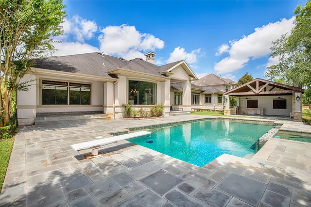 a view of a house with swimming pool and porch