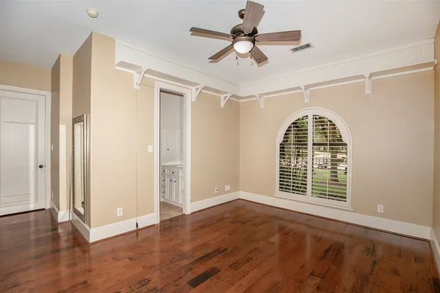 a view of a livingroom with wooden floor and a window