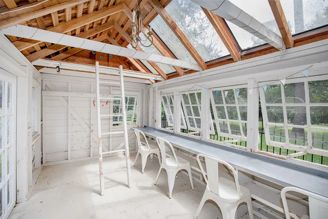 a view of a house with a yard and large tree
