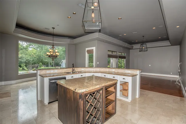 an open kitchen with kitchen island a sink stove and wooden floor
