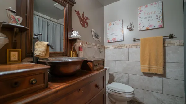 a bathroom with a sink a toilet and a shower