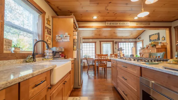 a large kitchen with lots of counter space a sink and appliances