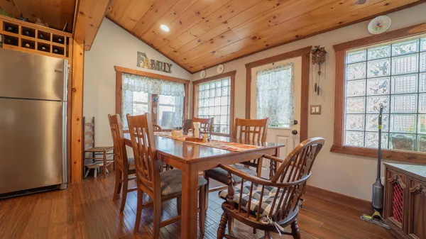 a view of a dining room with furniture window and wooden floor