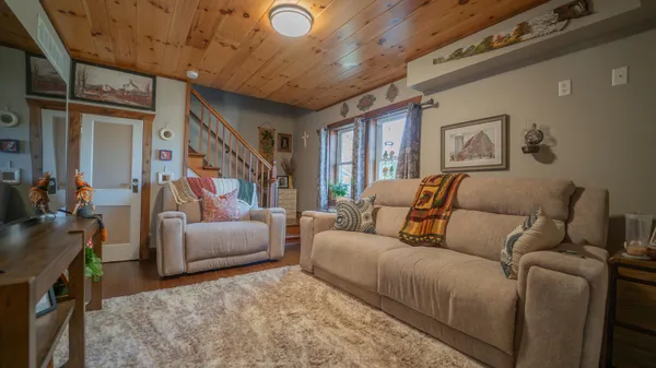 a living room with furniture and a ceiling fan