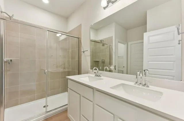 a bathroom with a shower sink and mirror