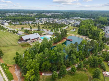an aerial view of a house with swimming pool and furniture