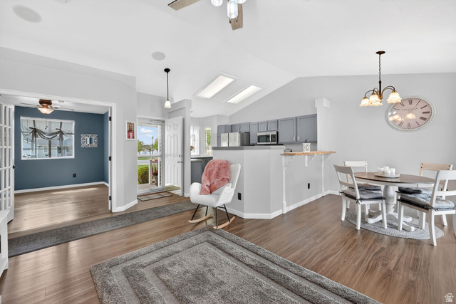 2190 West 1450th Street North Layton, UT 84041 - Photo 2 of 11 Spacious open-concept living area featuring wood-finish flooring, vaulted ceilings, and skylights