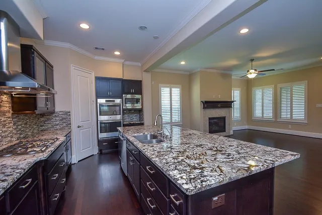 a kitchen with kitchen island a sink stove and refrigerator