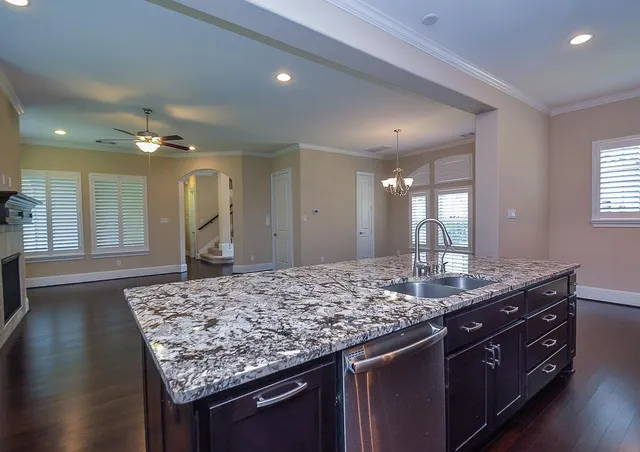 a bathroom with a granite countertop sink and a large mirror