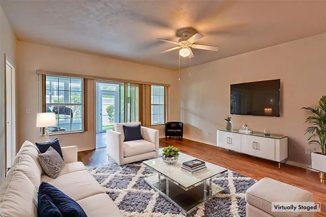 a living room with furniture a rug and a flat screen tv