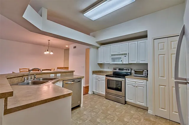 a kitchen with a stove a sink and a refrigerator