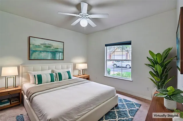 a bedroom with a large bed and a chandelier