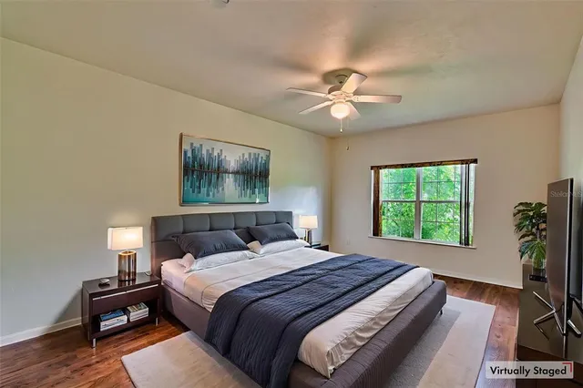a bedroom with a large bed and a chandelier